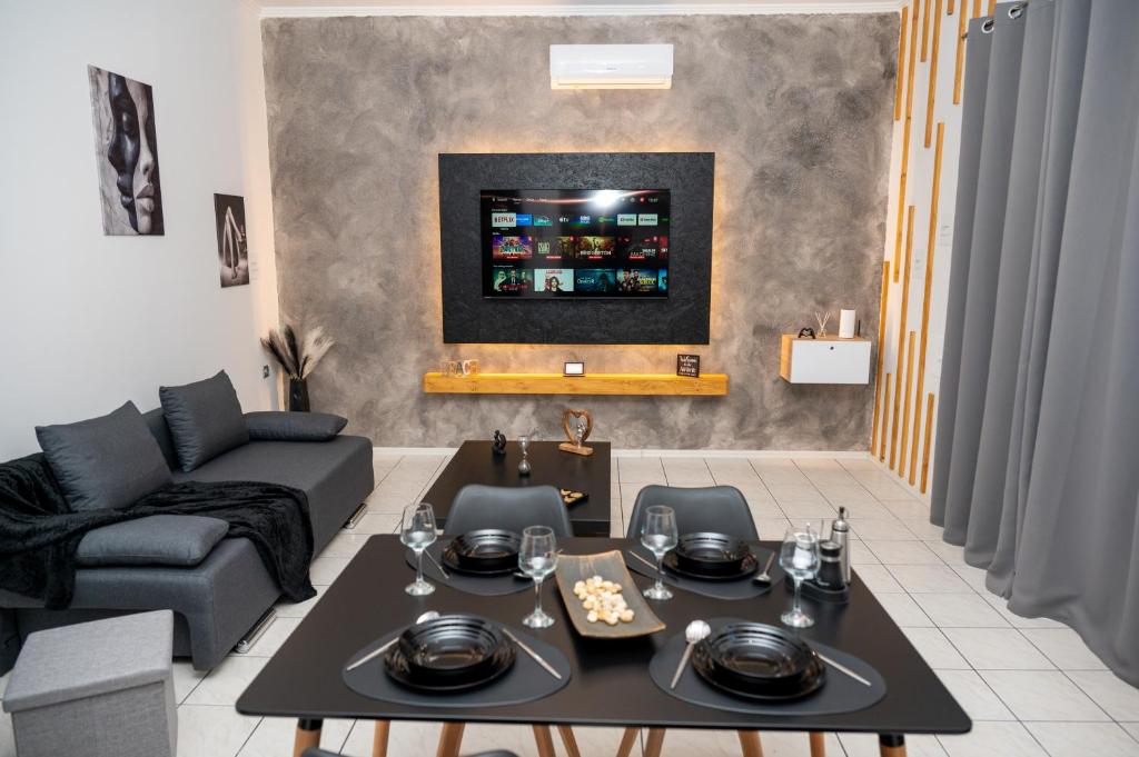 a living room with a table and a couch at Ottoka in Kos