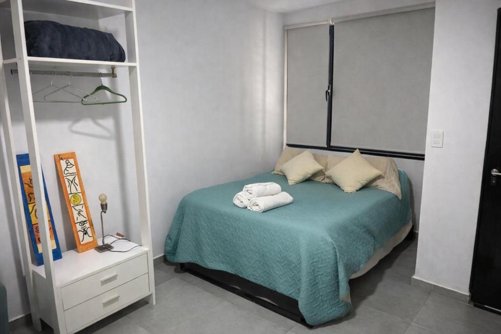 a bedroom with a bed with two towels on it at México 1510 - Neuquén Centro in Neuquén