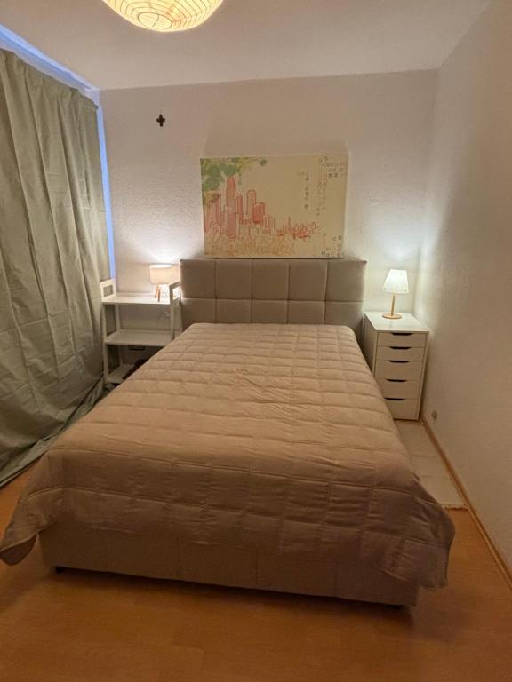 a bedroom with a large bed and a window at Privatquartier im Ortskern von Westerstede in Westerstede