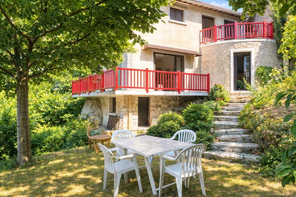 a patio with a table and chairs in front of a house at Les rives enchantées in Loches