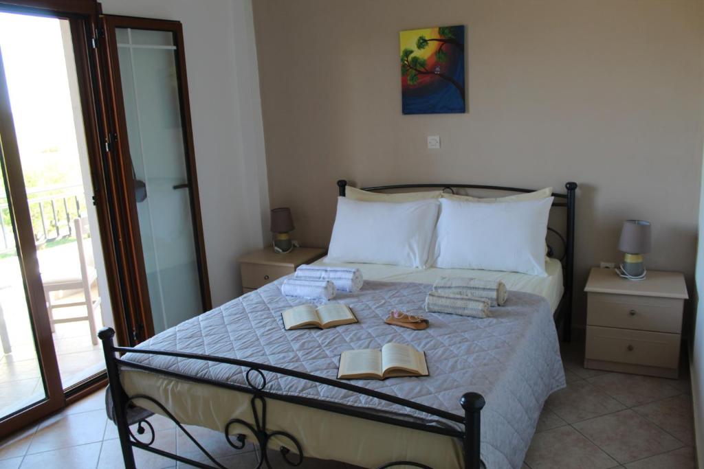 a bedroom with a bed with two slippers on it at Vakis Apartments 1 in Romanón