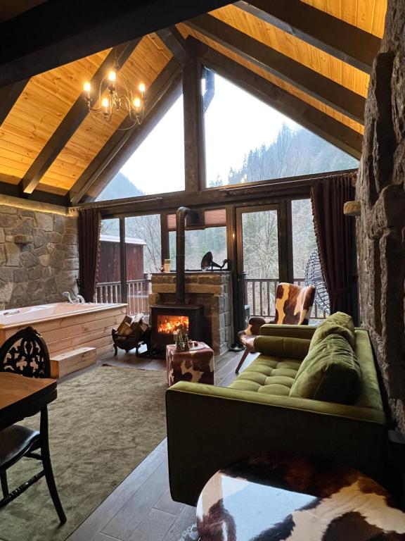 a living room with a couch and a fireplace at AYDER VANAK SUİTEs in Ayder Yaylasi