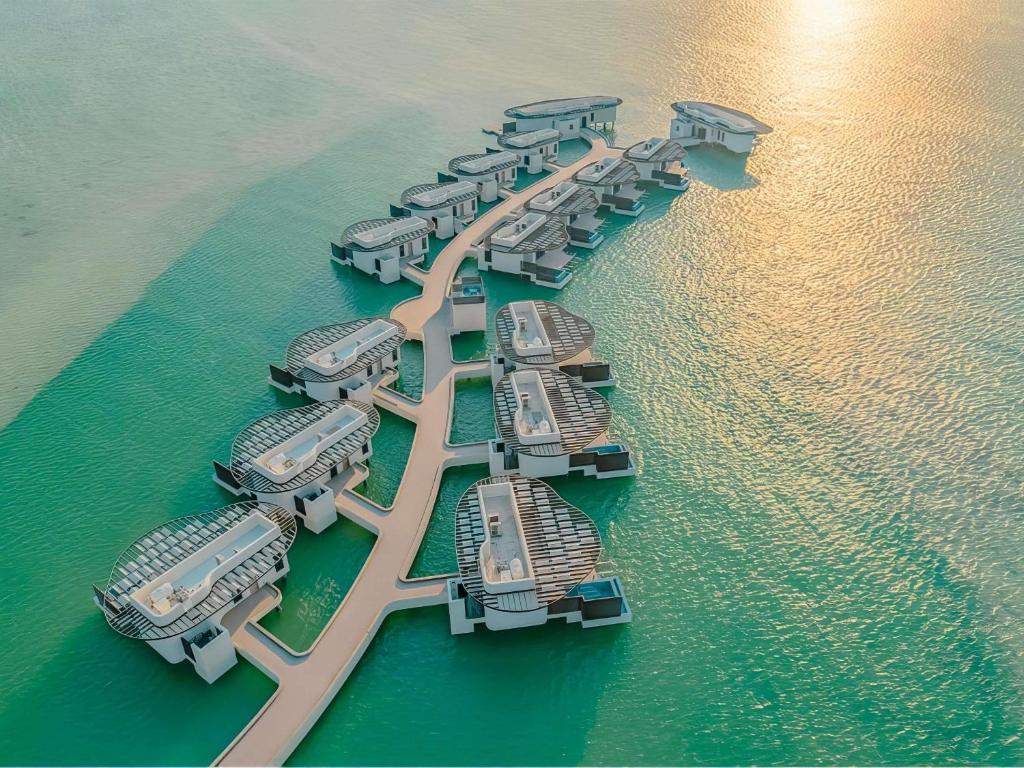 a group of boats in a row in the water at Hawar Resort By Mantis in Hawar Island