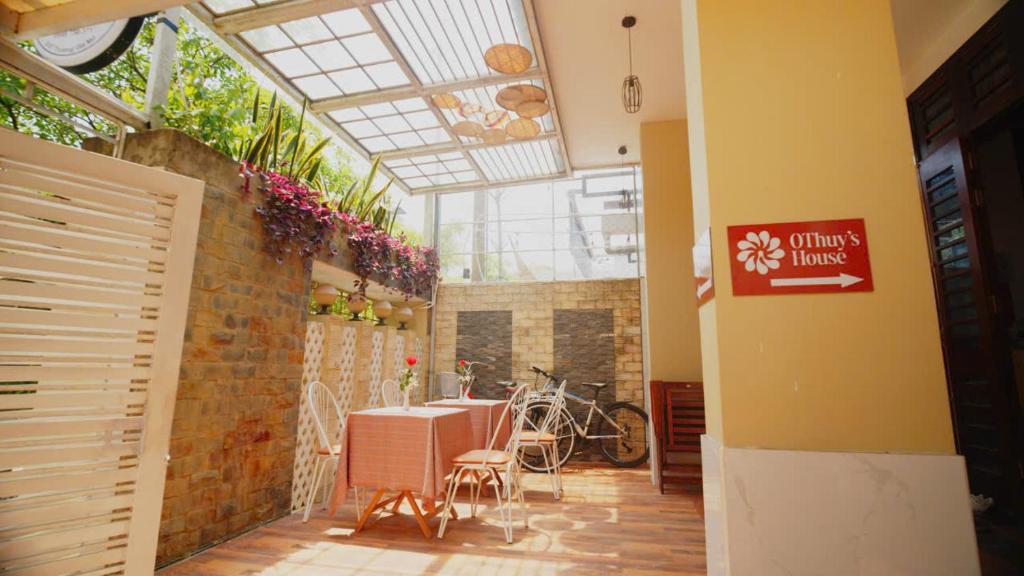a room with a table and chairs in a building at OThuy's House in Hue in Hue