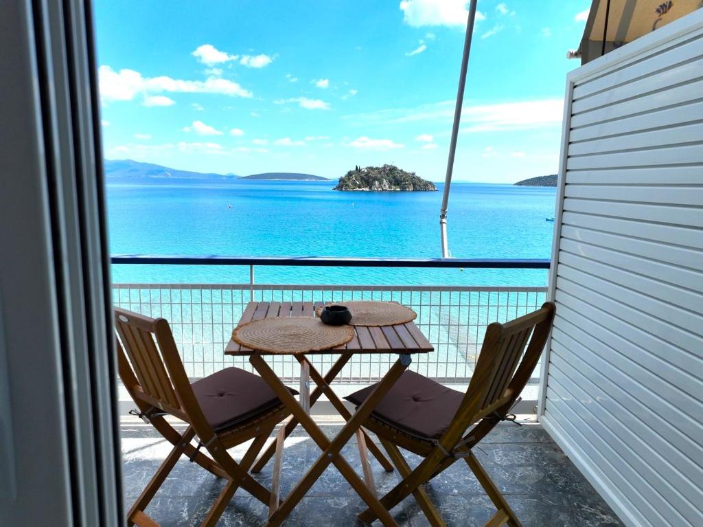 a table and chairs on a balcony with a view of the ocean at Captain's Tolo Sea View 2 in Tolo