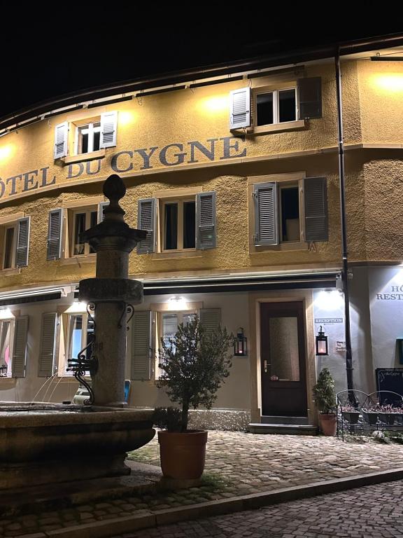 a building with a fountain in front of it at studio Bevaix in Bevaix
