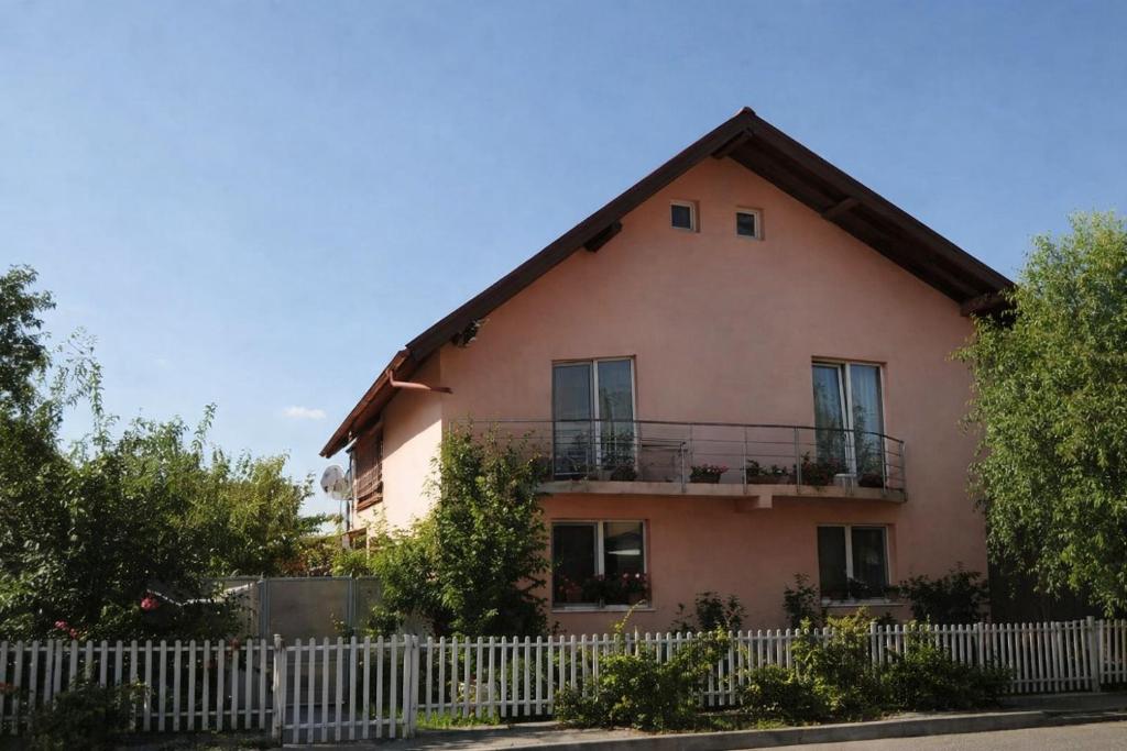 a house with a white fence in front of it at Casa Denis in Cristian