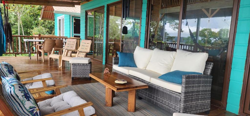a porch with a couch and chairs on a house at SEGUNDA BRISA in Tucker Bight