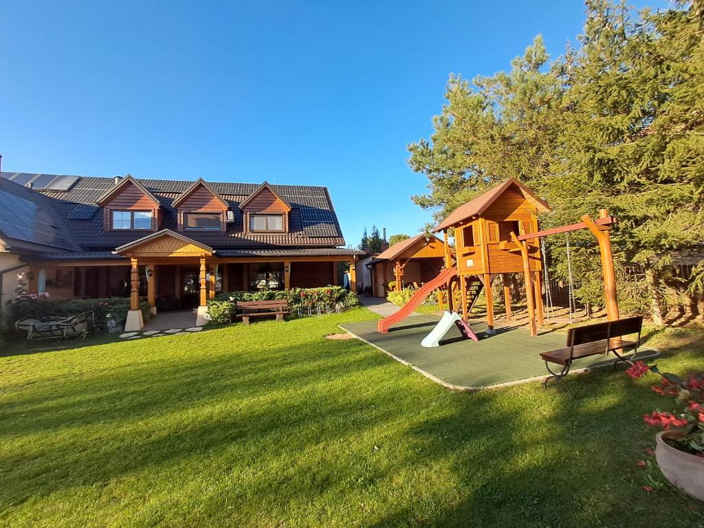 a yard with a playground and a house at Agroturystyka u Jarka in Bryzgiel
