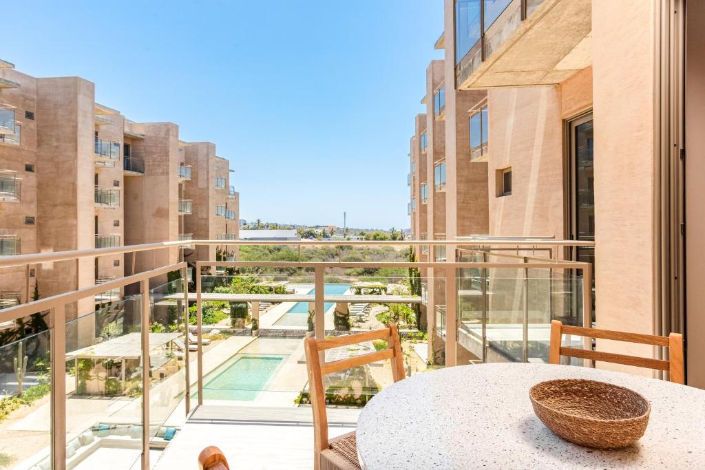 a balcony with a table and a view of a building at Las Arenas de Cabo in Cabo San Lucas