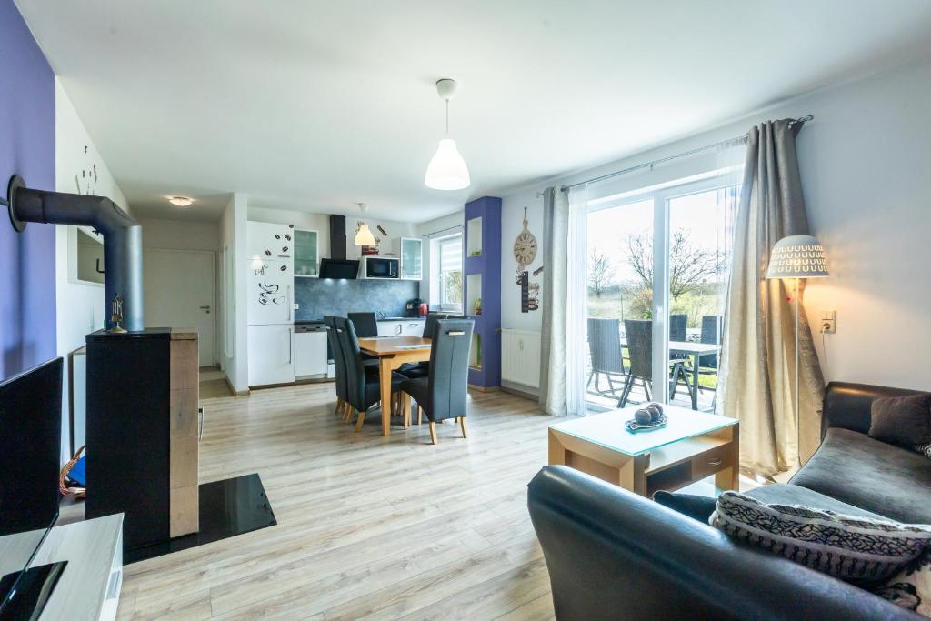 a living room and kitchen with a couch and a table at Ferienwohnung Waldeck am Edersee in Waldeck
