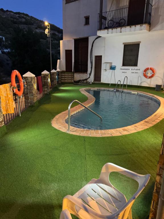 a swimming pool in the yard of a house at Arroyo Alpujarra in Guarros