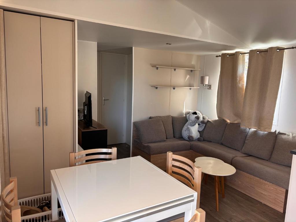 a living room with a couch and a table at Camping siblu in Lattes