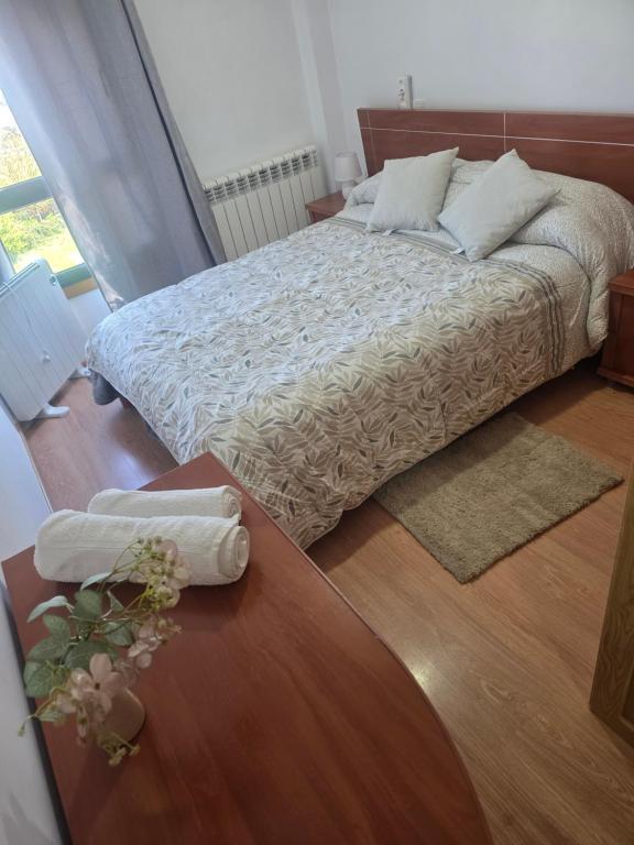 a bedroom with a bed and a wooden floor at Casa de sney in Sarria
