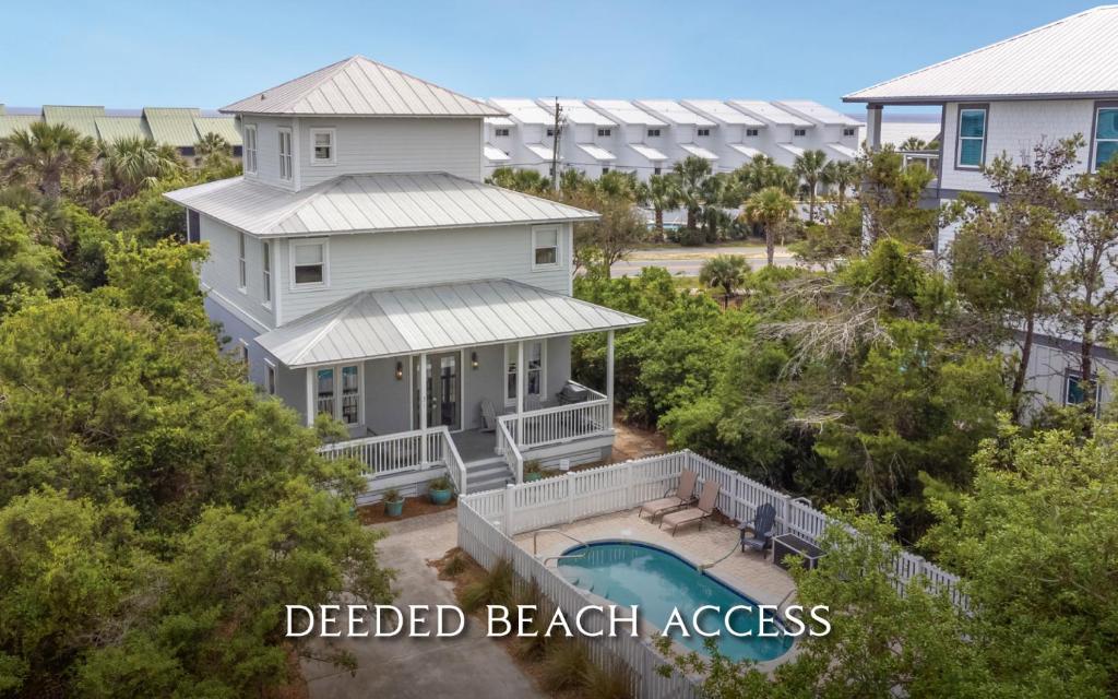 an aerial view of a white beach house with a pool at Ritz Clareon by Oversee 30A in Seacrest