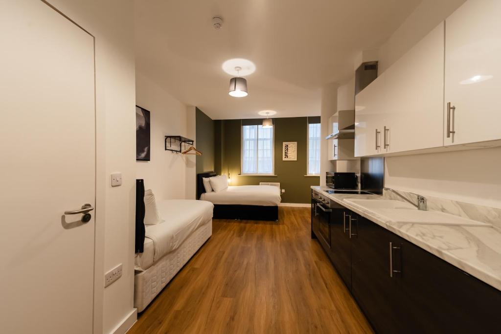 a kitchen with a couch and a bed in a room at 8 Stanley Street Apart-Hotel in Liverpool