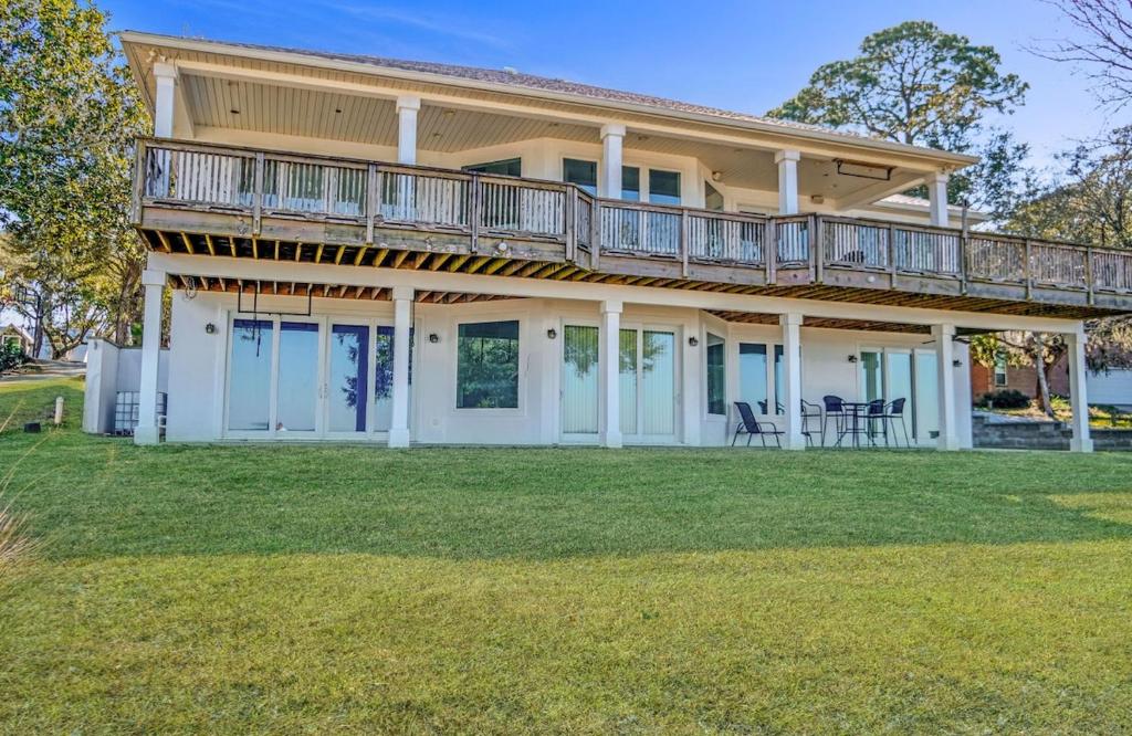 a large house with a balcony on top of it at Salty Bay Hideaway in Gulf Breeze