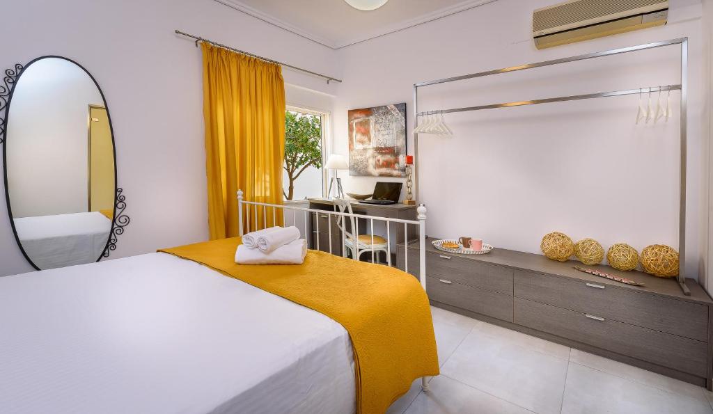 a bedroom with a large bed and a mirror at Lithinon House in Chania