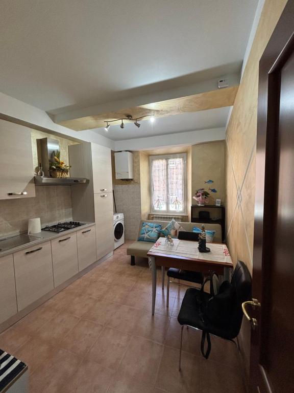 a kitchen with a table and a dining room at Da Li Al Mar in Savona