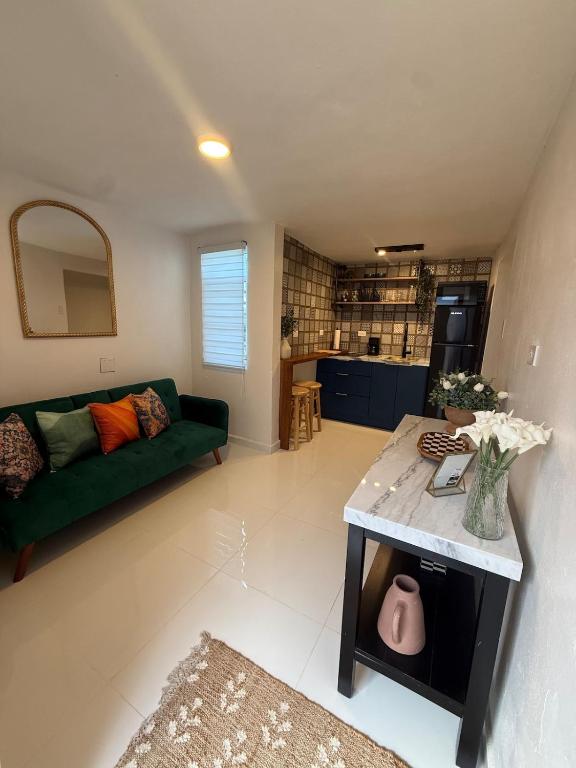 a living room with a green couch and a table at Gibertino by Cinque Terre in Isabela