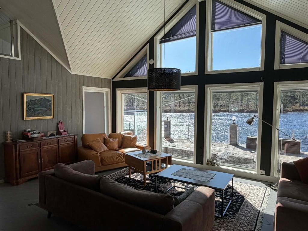 a living room with a couch and a table at Villa Heyerdahl Main House in Åmli