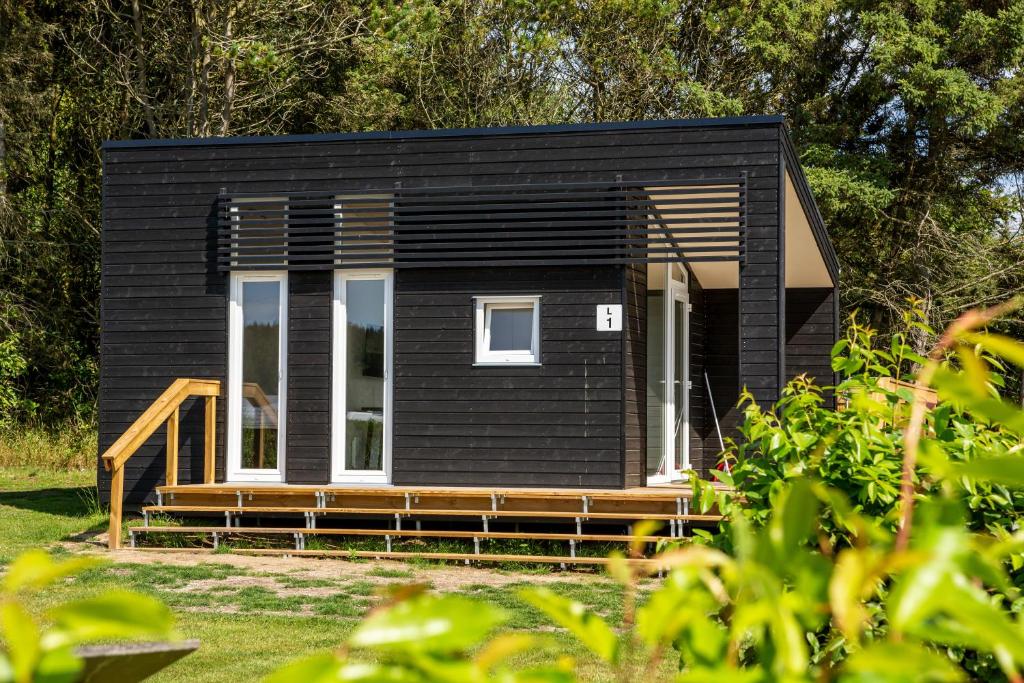 a black tiny house with a black exterior at DCU-Camping Tranum in Brovst