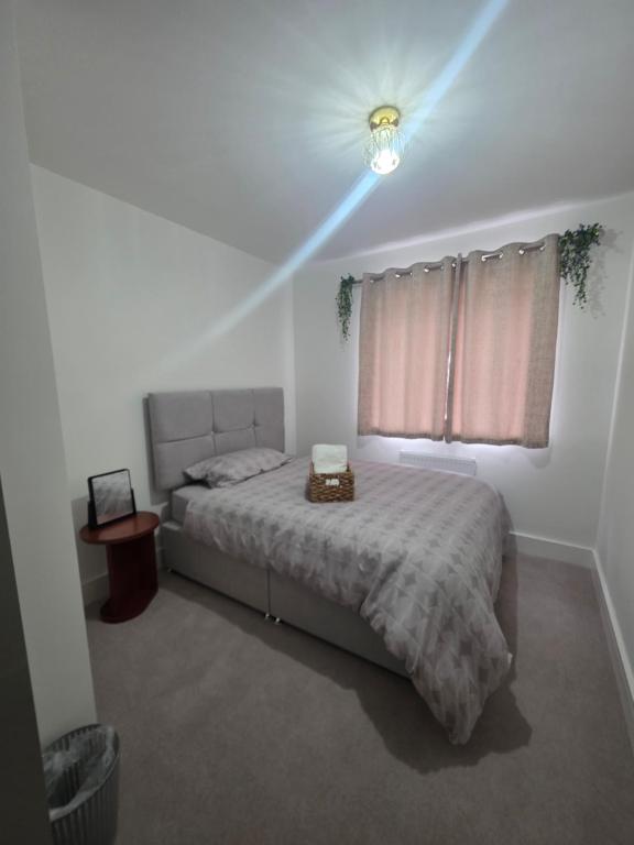 a bedroom with a bed and a window with a light at HomeAway Comfort in Minster