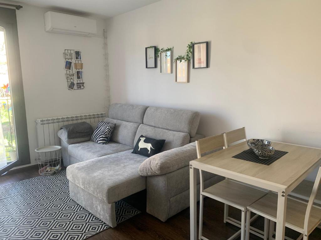 a living room with a couch and a table at El Relax, La Puebla De Castro in La Puebla de Castro