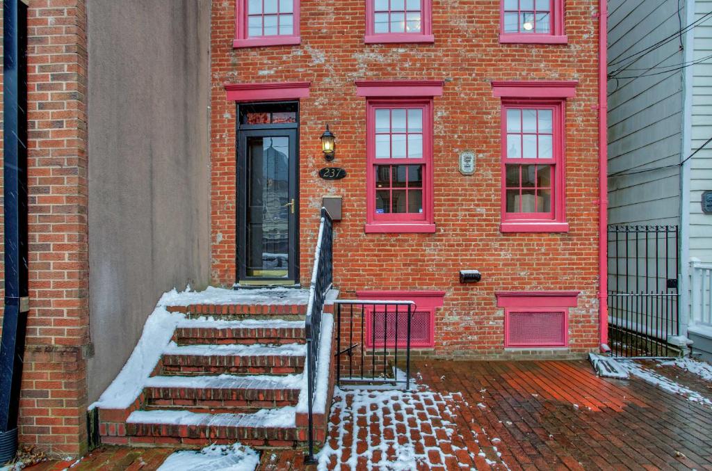 a red brick building with snow on the steps at Luxe Row Home Steps to USNA Gate 3 in Annapolis