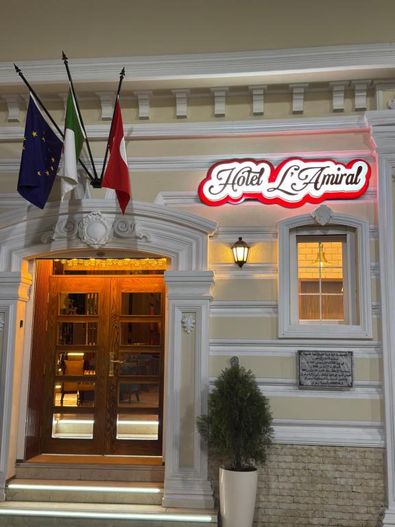 a restaurant with flags on the side of a building at Amirale in Oran