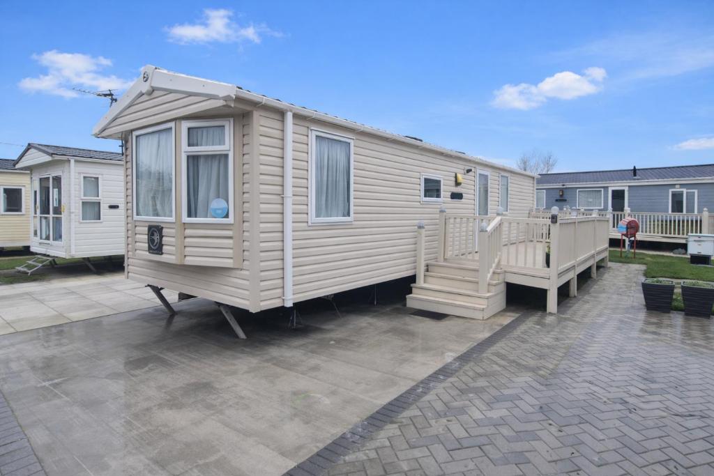 a tiny house is sitting on a patio at Towyn Winkups F07 in Rowen