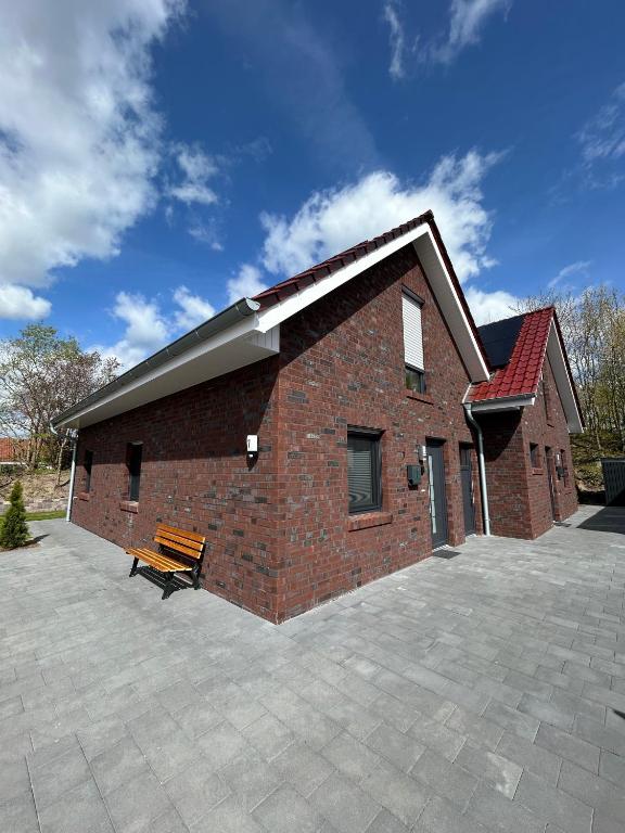 a brick building with a bench in front of it at Seeidylle in Geeste