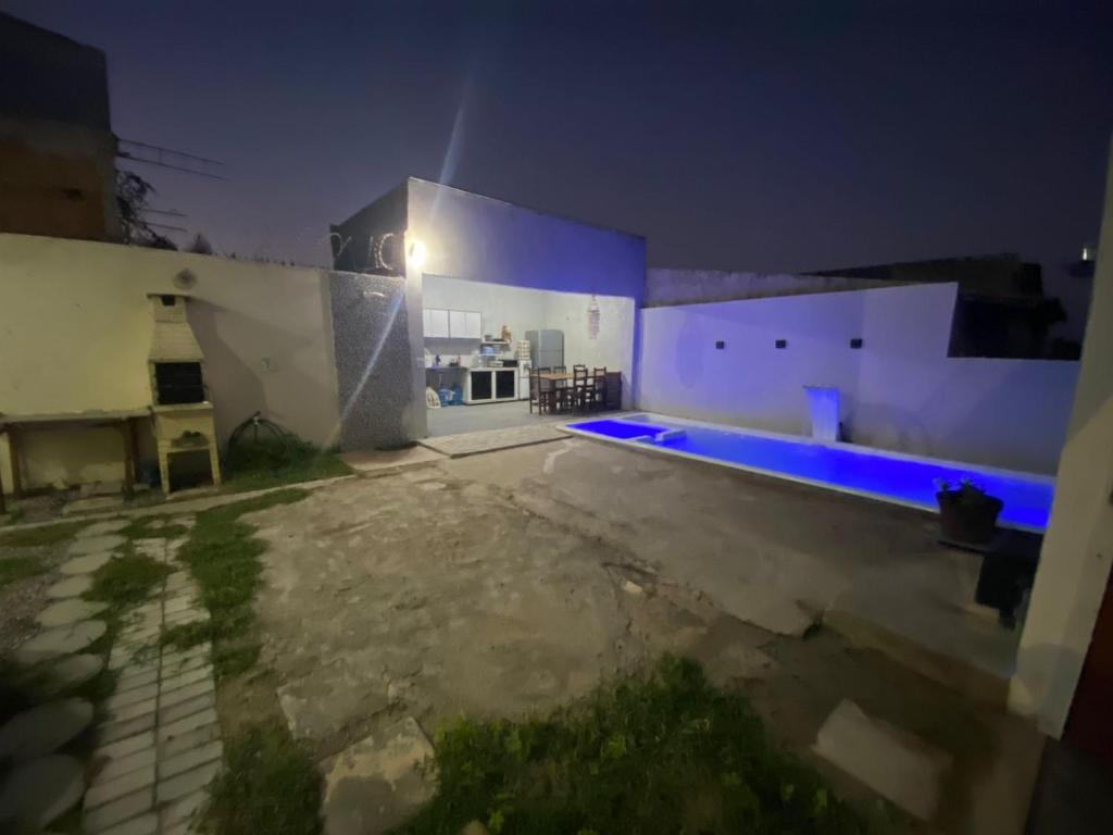 a house with a swimming pool at night at Casa do Arruda na tabuba in Caucaia