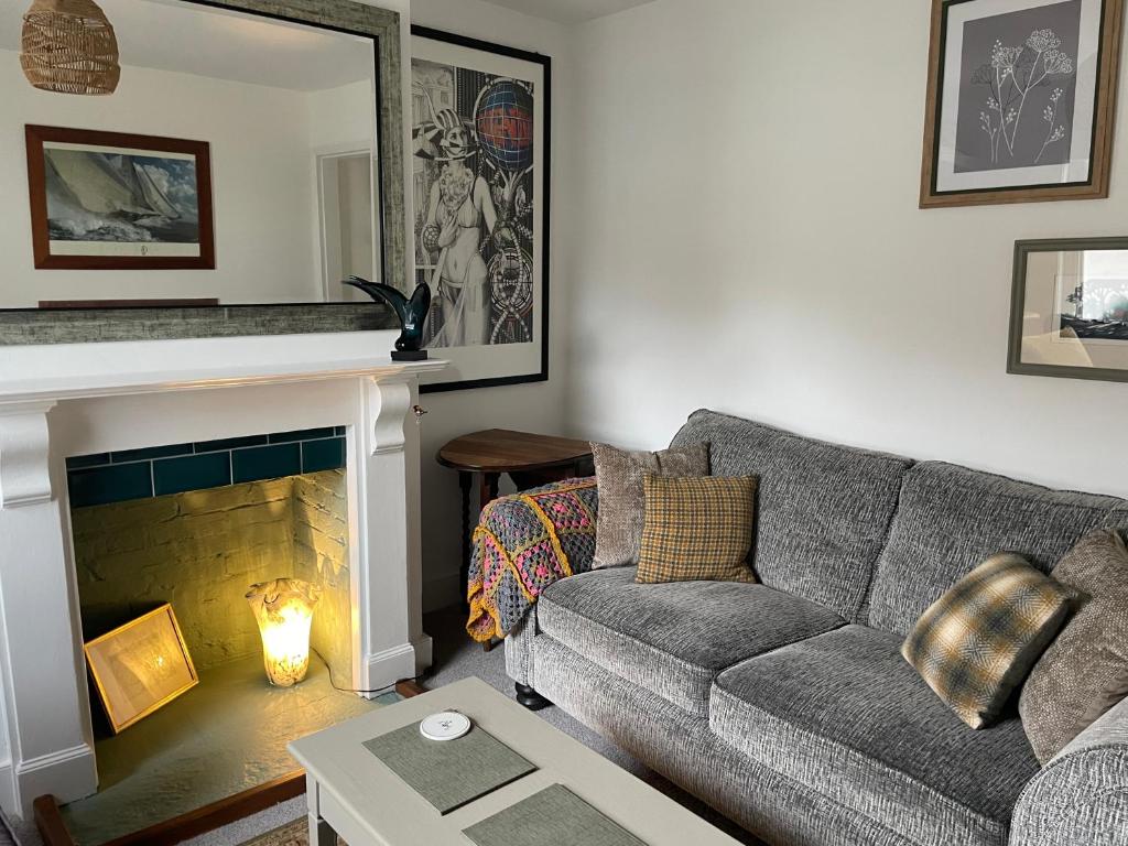 a living room with a couch and a fireplace at No 28 cosy cottage in the heart of Cowes in Cowes