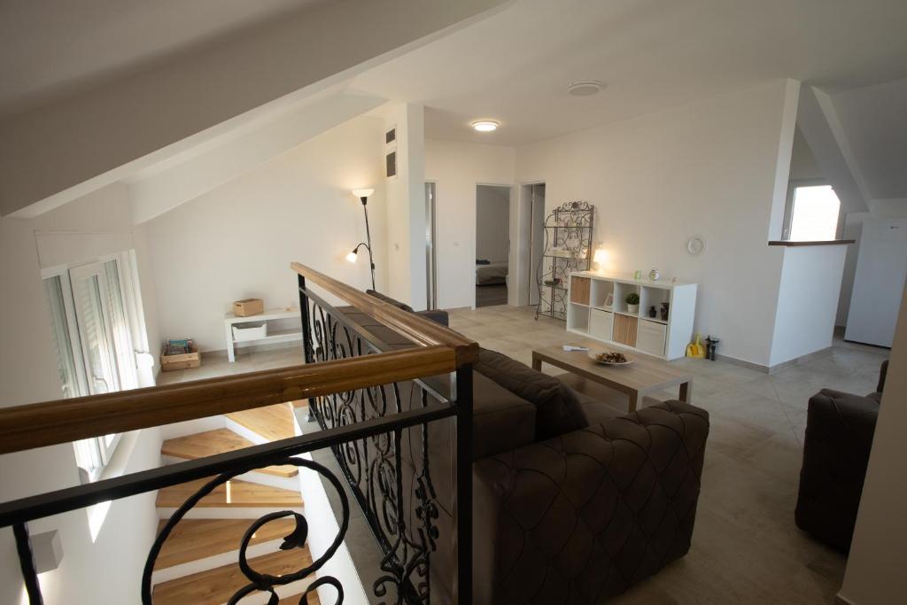 a living room with a couch and a staircase at Familija in Belgrade