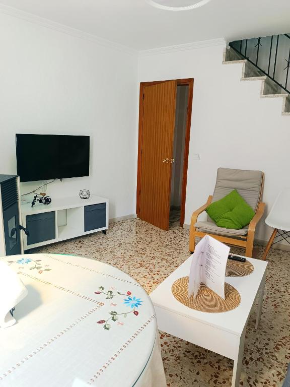 a living room with a tv and a table and a chair at Casa Corzo in María