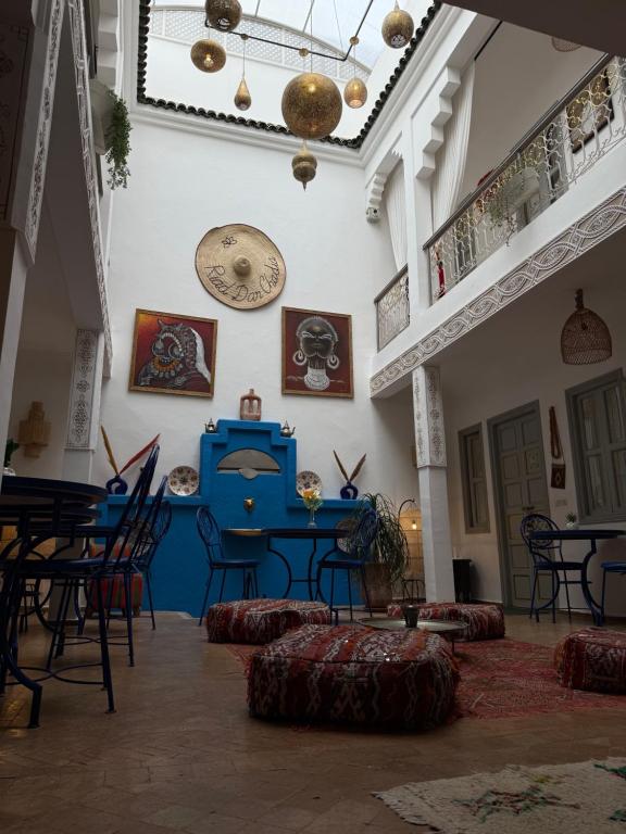 a room with chairs and tables and a blue table at Riad Dar Chadia in Marrakesh