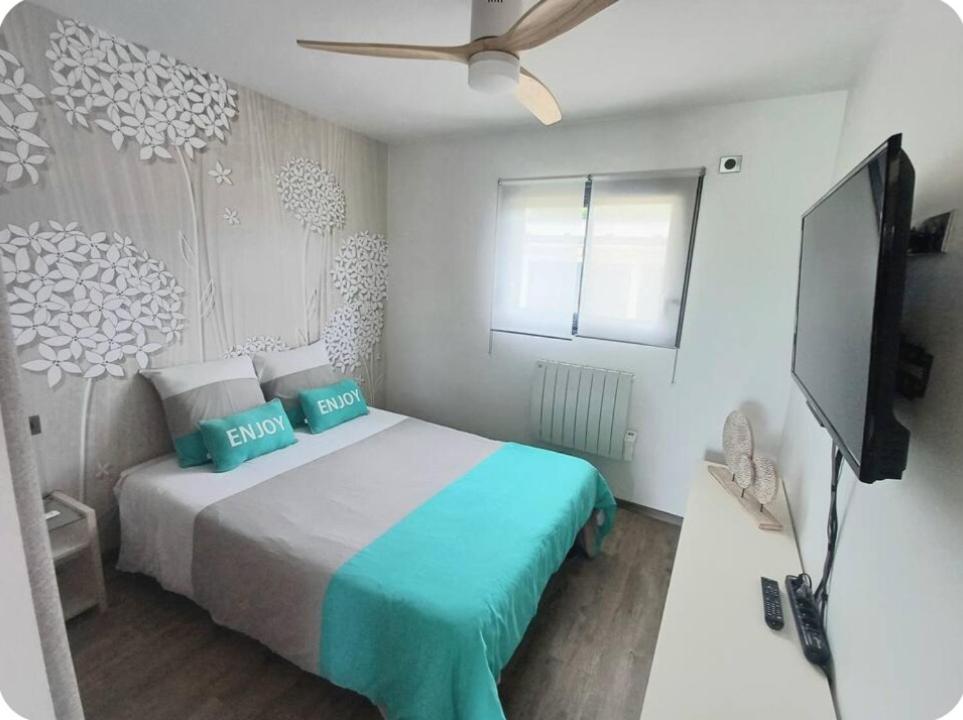 a bedroom with a bed and a flat screen tv at Maison cosy in Grésy-sur-Aix