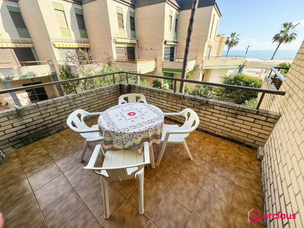 a patio with a table and chairs on a balcony at Poble Mar 8 in Oropesa del Mar