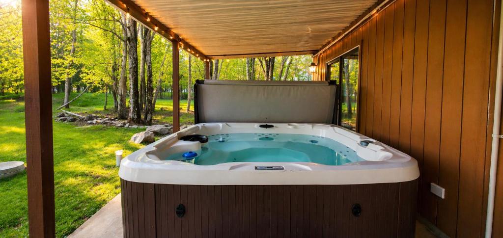 a jacuzzi tub sitting inside of a house at Pickleball Pool Table Hot Tub FirePit King Bed in Blakeslee