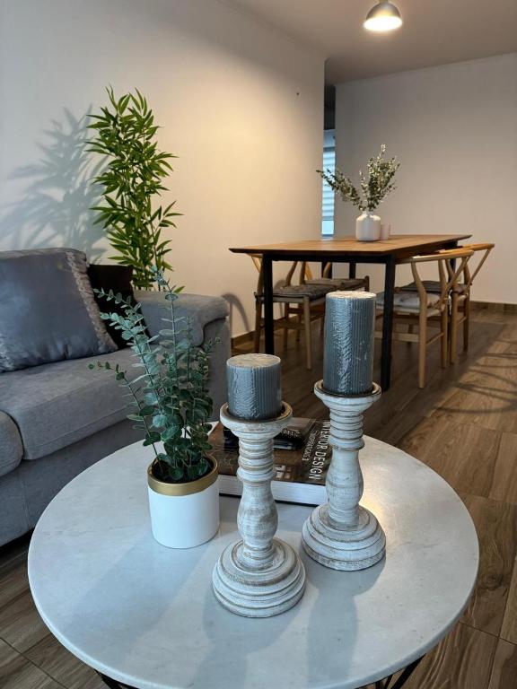 a living room with a table with two vases at Apartment in Lima JM in Lima