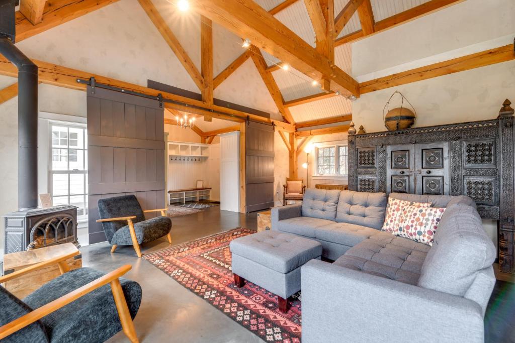 a living room with a couch and a fireplace at Hike, Bike, & Explore: Vermont Family Farmhouse! in New Haven