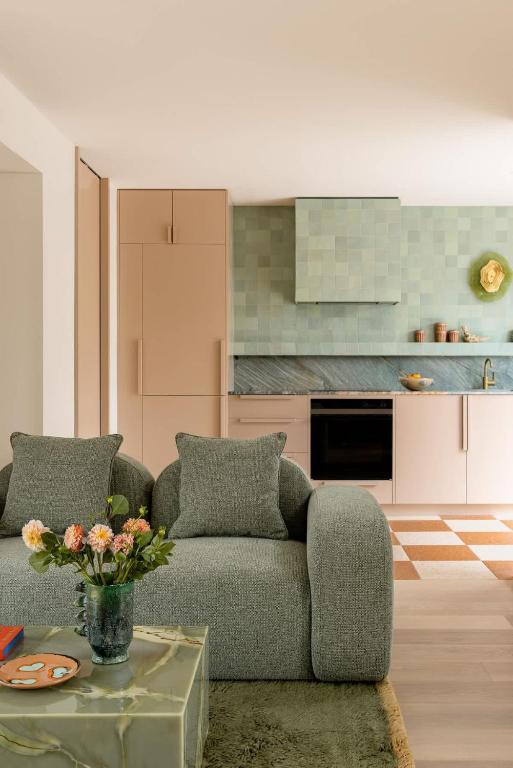 a living room with a couch and a kitchen at Bon Bon Apt 1 - Papi in Orange