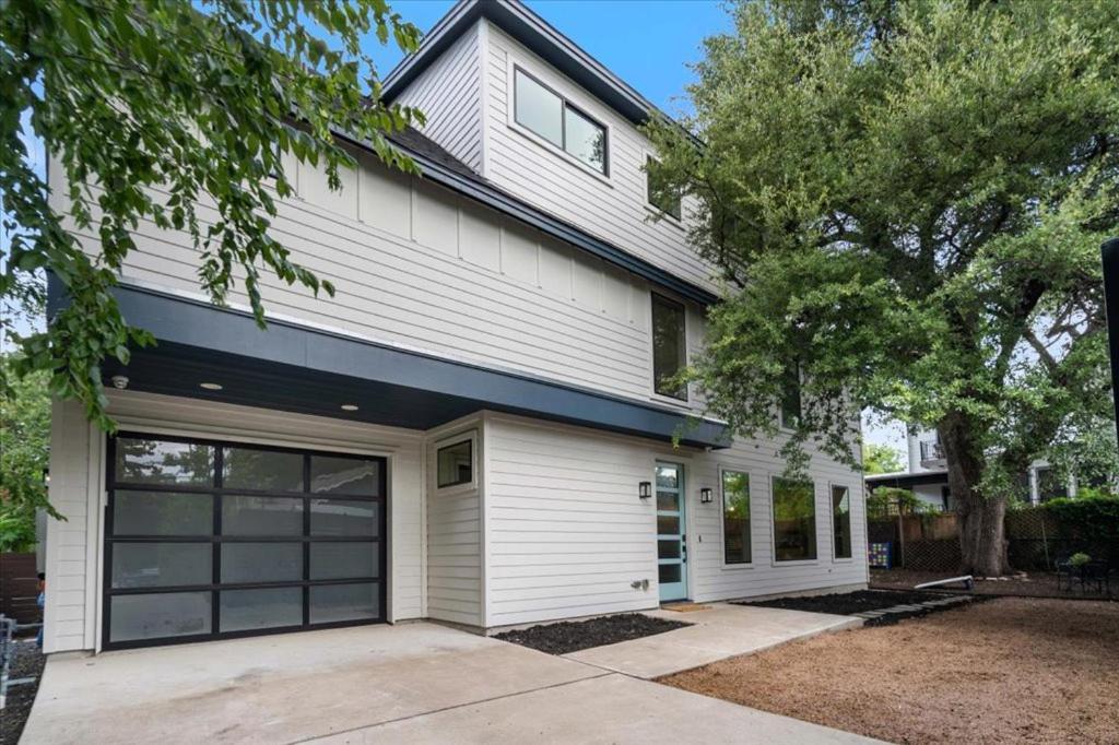 a white house with a garage at Spacious 5BR Central Austin Home Sleeps 13 in Austin