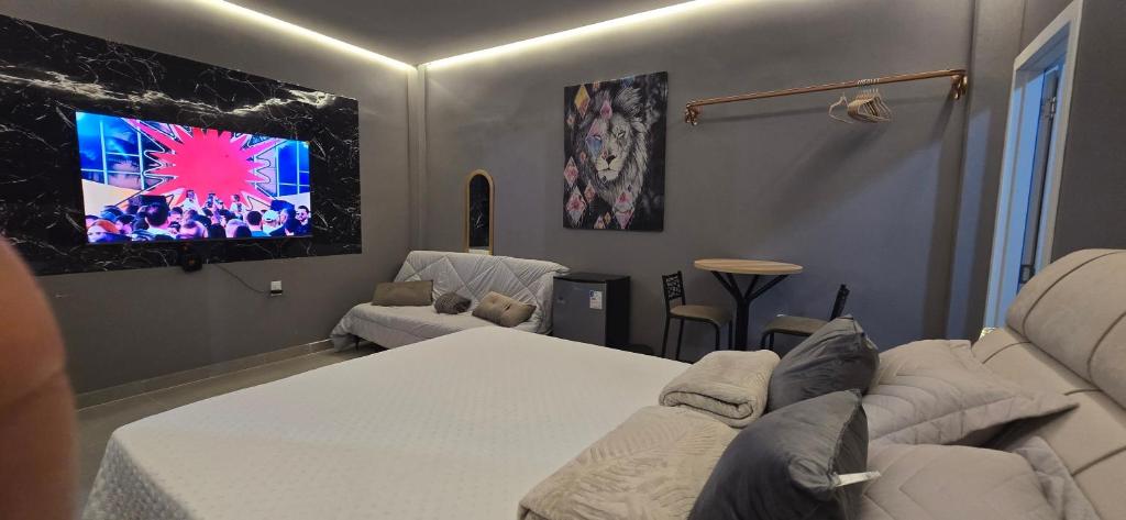 a living room with a couch and a tv at Girassol & Estética in Macapá