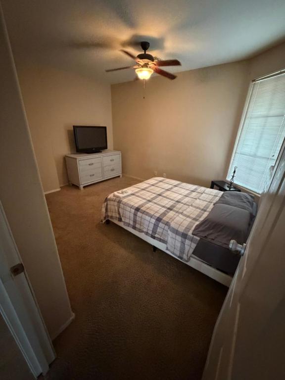 a bedroom with a bed and a ceiling fan at Goodyear Cul-de-sac Room 5 in Goodyear