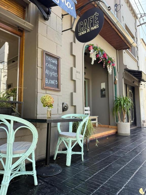 a table and chairs sitting outside of a cafe at La Josefina Hotel Boutique in Olavarría