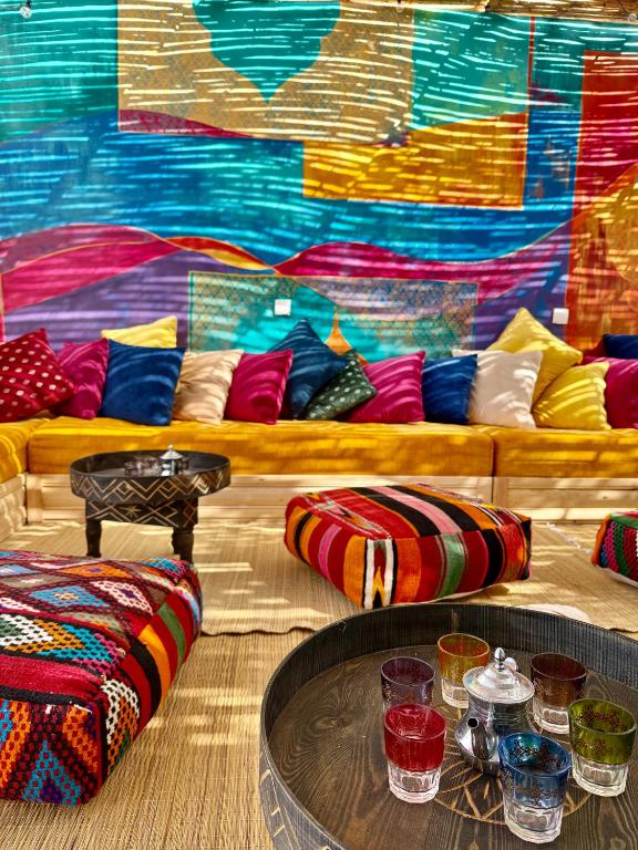 a living room with a couch with colorful pillows at SeArt Home by the Ocean in Aourir