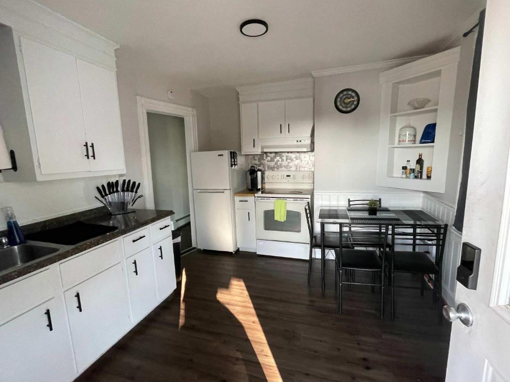 a kitchen with white cabinets and a table with a dining room at Private Apt In Middletown-wesleyan in Middletown