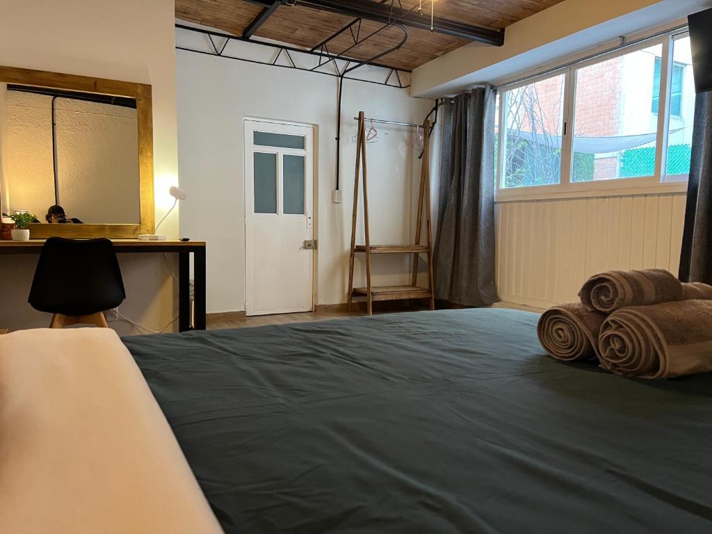 a bedroom with a bed and a large window at Discover Condesa Ideal Location in Mexico City